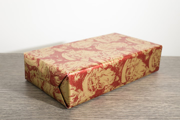 Christmas gift with colored paper on a wood table
