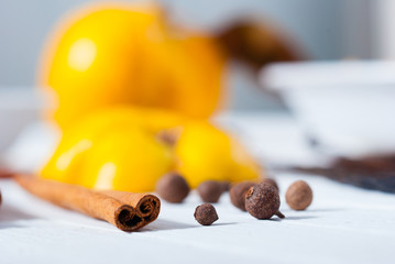 allspice and cinnamon rolls, quince jelly dessert ingredients on white wood table