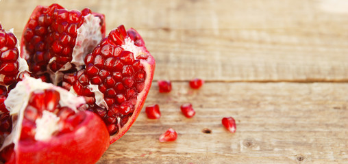 Pomegranate fruit isolated. Pomegranate grains. Pomegranate close up on wooden table.