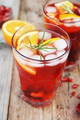 Red wine cranberry citrus pomegranate sangria. Top view, rustic wooden background.