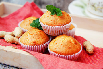 Homemade muffin on orange napkin, on the rustic background. Selective focus.