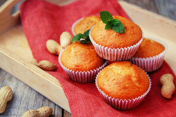 Homemade muffin on orange napkin, on the rustic background. Selective focus.