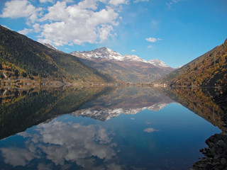 The Poschiavo lake with the reflection of the mountains
