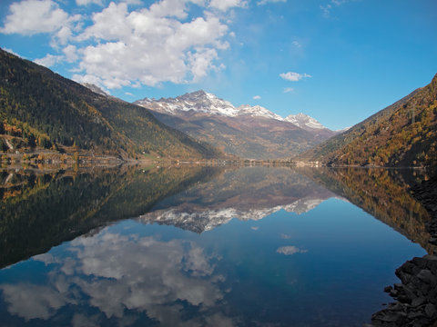 The Poschiavo lake with the reflection of the mountains
