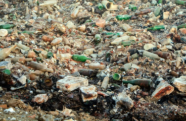 Large garbage dump waste with broken bottles