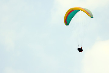 Paragliding over the mountains against clear blue sky