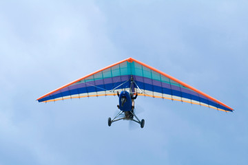 Fototapeta na wymiar Extreme flight on deltaplane in a blue sky