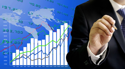 Businessman analyzing growth graph with world map background