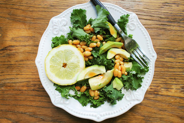 Vegan salad with avocado, white bean and Vinaigrette dressing . Top view