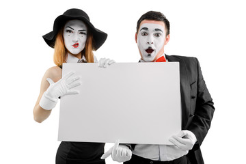 Mimes holding big blank card