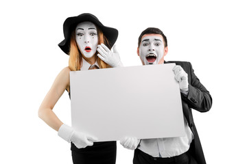Two mimes holding white card