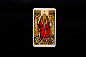 An individual major arcana tarot card isolated on black background. The Hierophant.