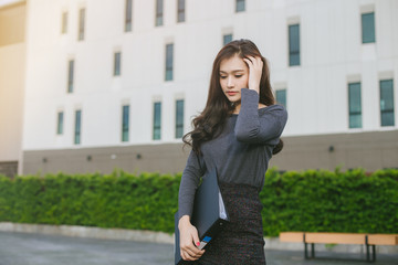 Fototapeta premium Asian business woman is stressed. Asian Young business woman unemployed. Asian office girl unemployed.