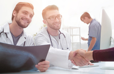 group of doctors welcoming their customer with a handshake