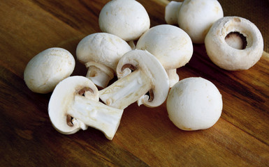Agaricus bisporus or portobello mushroom on wooden floor.