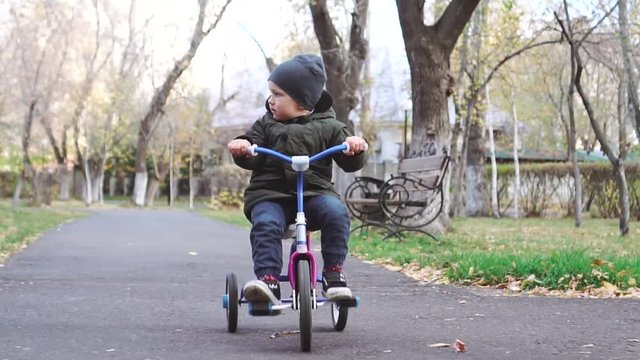 Child riding a tricycle outdoors