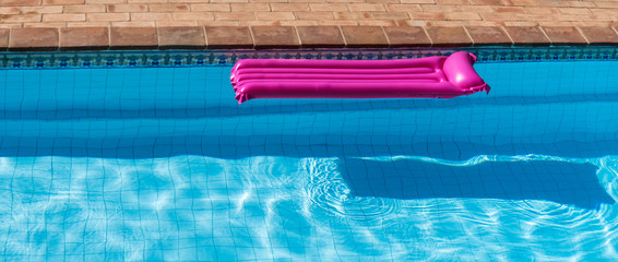 pink air mattress in the pool