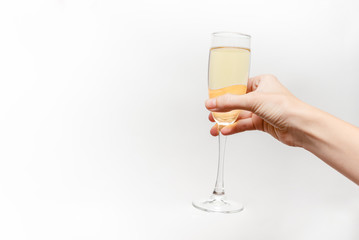 Femal hand holding champagne glass. Holiday Concept. White background, isolated, close up