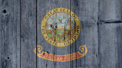 USA Politics News Concept: US State Idaho Flag Wooden Fence