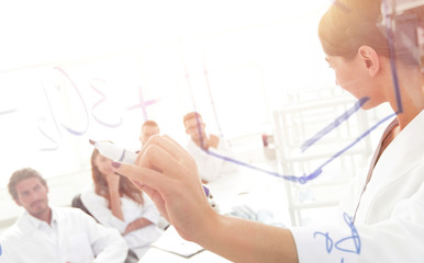 Naklejka premium view through the transparent Board. female biochemist makes a report to colleagues