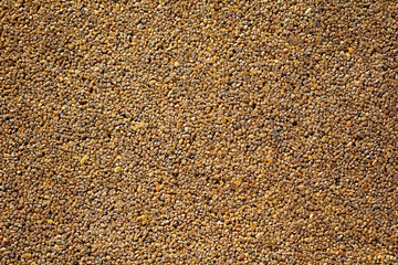 Small yellow stones on the road surface as background