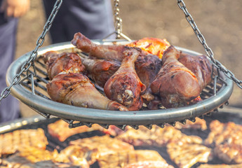 Chef fries meat on the grill in nature