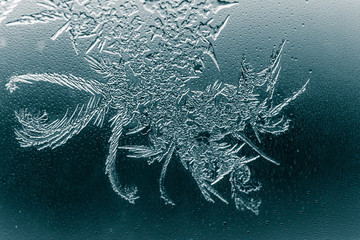 Snow patterns on glass as an abstract background