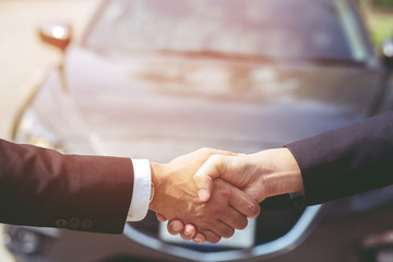 Closeup of a business man hand shake between two colleagues greet , Represents Friendship is good,success, congratulations. Good deal. Close-up of handshaking. Smooth business. purchase buy car new.  