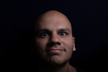 Obraz premium Portrait of Bald Man on Black Background