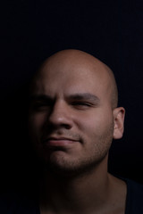 Portrait of Bald Man on Black Background