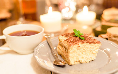 tiramisu by candlelight, romantic date in Italy, tiramisu dessert on a porcelain plate