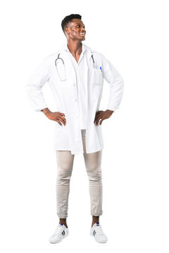 Full Body Of African American Doctor Posing With Arms At Hip And Laughing On White Background