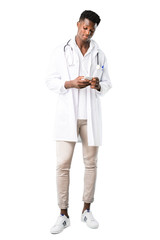 Full body of African american doctor talking to mobile on white background