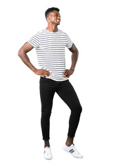 Fototapeta premium Full body of Dark skinned man with striped shirt posing with arms at hip on white background