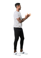 Full body of Dark skinned man with striped shirt smiling and applauding on white background