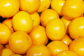 Fresh Mandarins spread out evenly in the shop window.