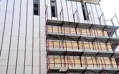 Building facade of the 60s during renovations. Brescia, Italy.