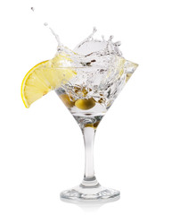 Martini splash with drops and olives in a transparent glass