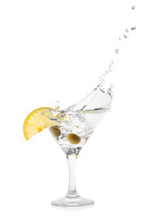 Martini splash with lemon and green olives in a transparent cock