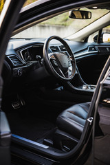 Luxurious car interior view through the open drivers door