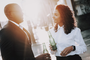 Alcoholic Beverage. Man and Woman. Stand. Street.