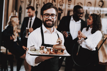Barman. Burger on Plate. Fun. Together in Bar.