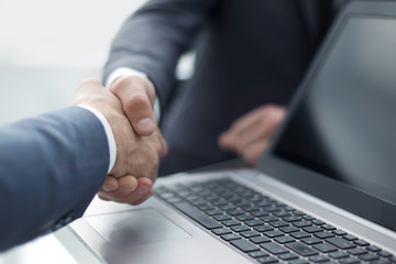 close up.business colleagues shaking hands with each other