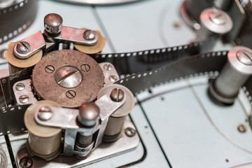 Rollers and cogs of a vintage film projector or video editing table.