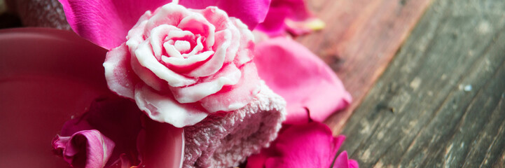 Spa settings with roses. Fresh roses and rose petals in a bowl of water and various items used in spa treatments