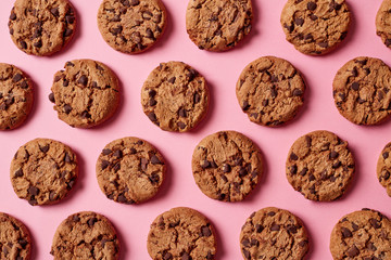 Fresh chocolate chip cookies pattern on pink background