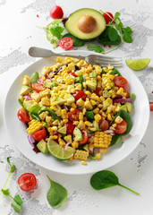 Sweet Corn salad with tomatoes, avocado, red onion, herbs and lime