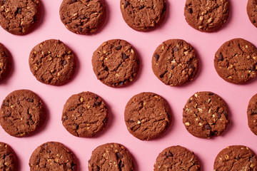 Fresh chocolate chip cookies pattern on pink background