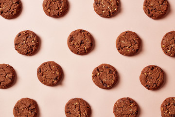 Fresh chocolate chip cookies pattern on pink background