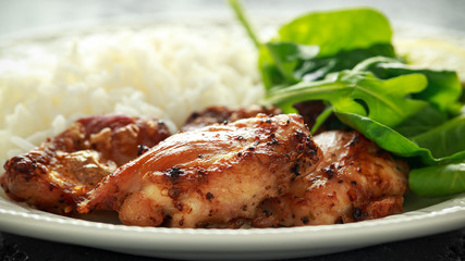 Roasted boneless skinless chicken thighs with rice and green vegetables mix